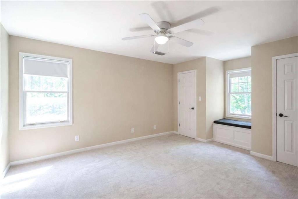 1660 A Maple Ridge Drive Loganville, GA 30052 - Photo 31 of 51 an empty room with windows and fan
