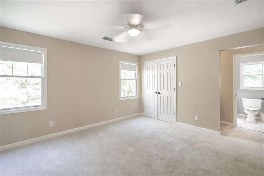 1660 A Maple Ridge Drive Loganville, GA 30052 - Photo 33 of 51 an empty room with windows and closet