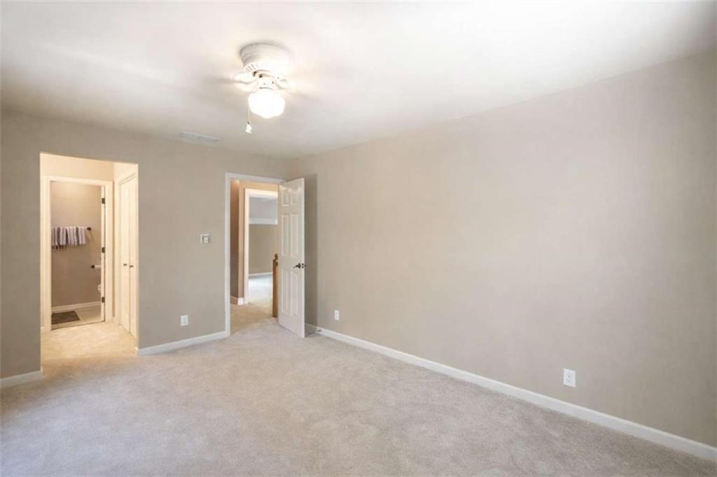 1660 A Maple Ridge Drive Loganville, GA 30052 - Photo 35 of 51 an empty room with fan and entrance