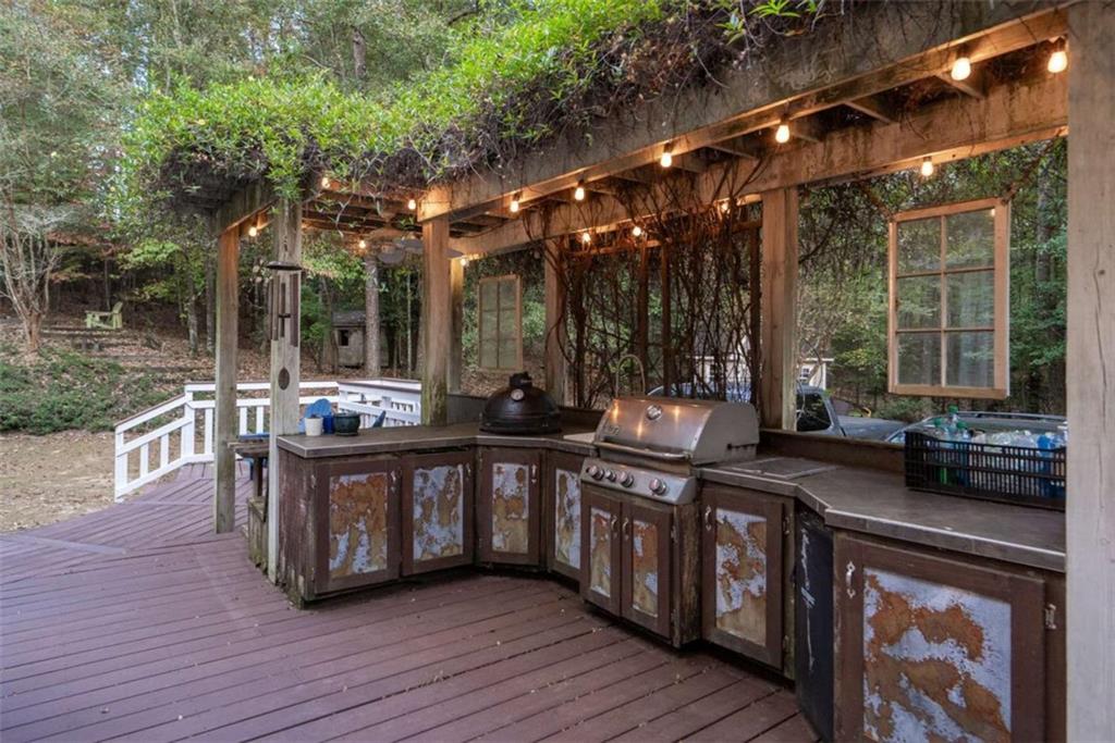1660 A Maple Ridge Drive Loganville, GA 30052 - Photo 44 of 51 a open kitchen with stainless steel appliances granite countertop a stove and a wooden floors