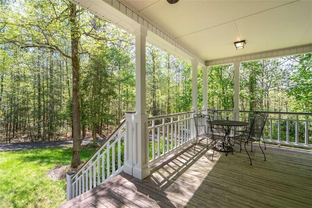 1660 A Maple Ridge Drive Loganville, GA 30052 - Photo 6 of 51 a view of a balcony with chairs and wooden floor