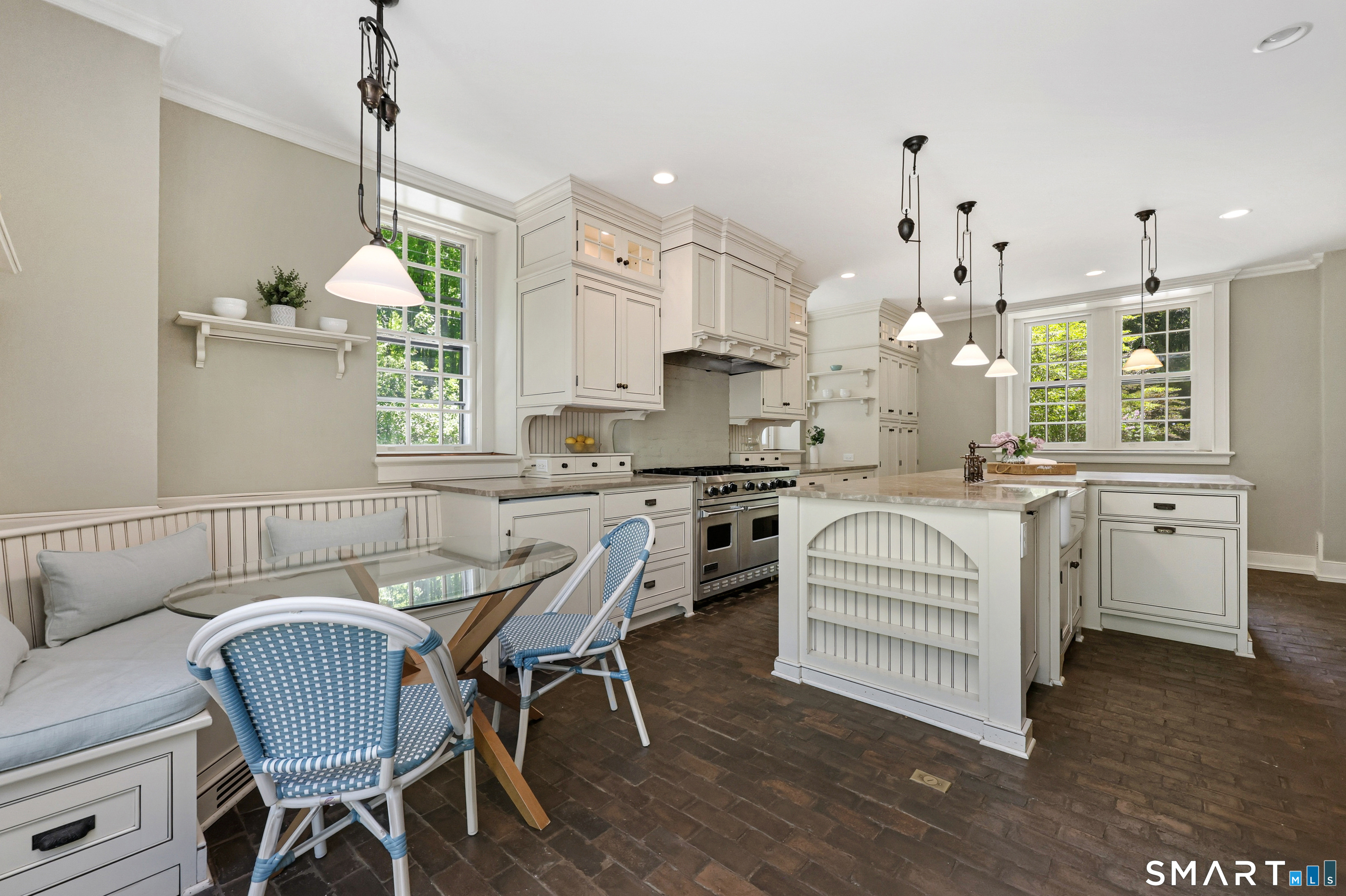 4 Old Barlow Mountain Road Ridgefield, CT 06877 - Photo 15 of 40 a kitchen with a dining table chairs stainless steel appliances and cabinets