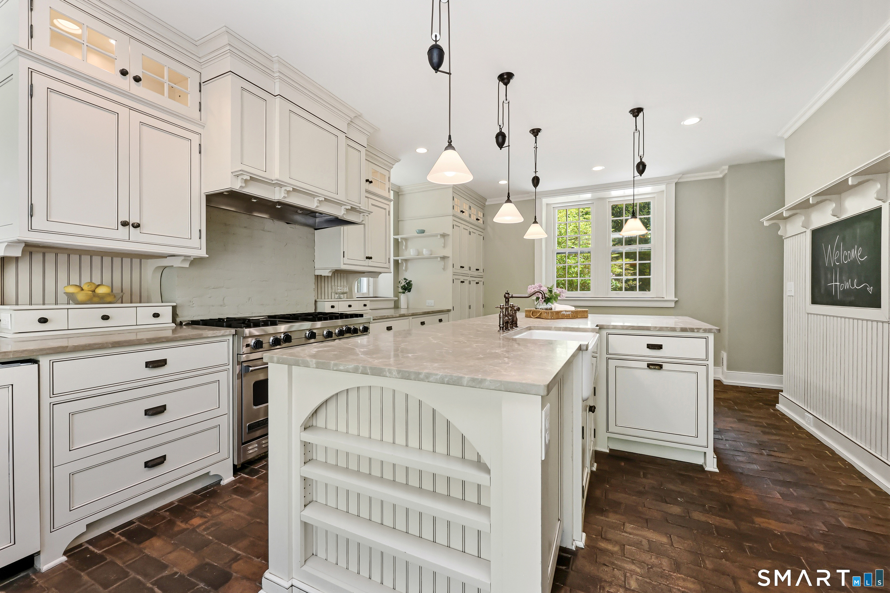 4 Old Barlow Mountain Road Ridgefield, CT 06877 - Photo 16 of 40 a kitchen with granite countertop a white stove top oven a chimney and a center island