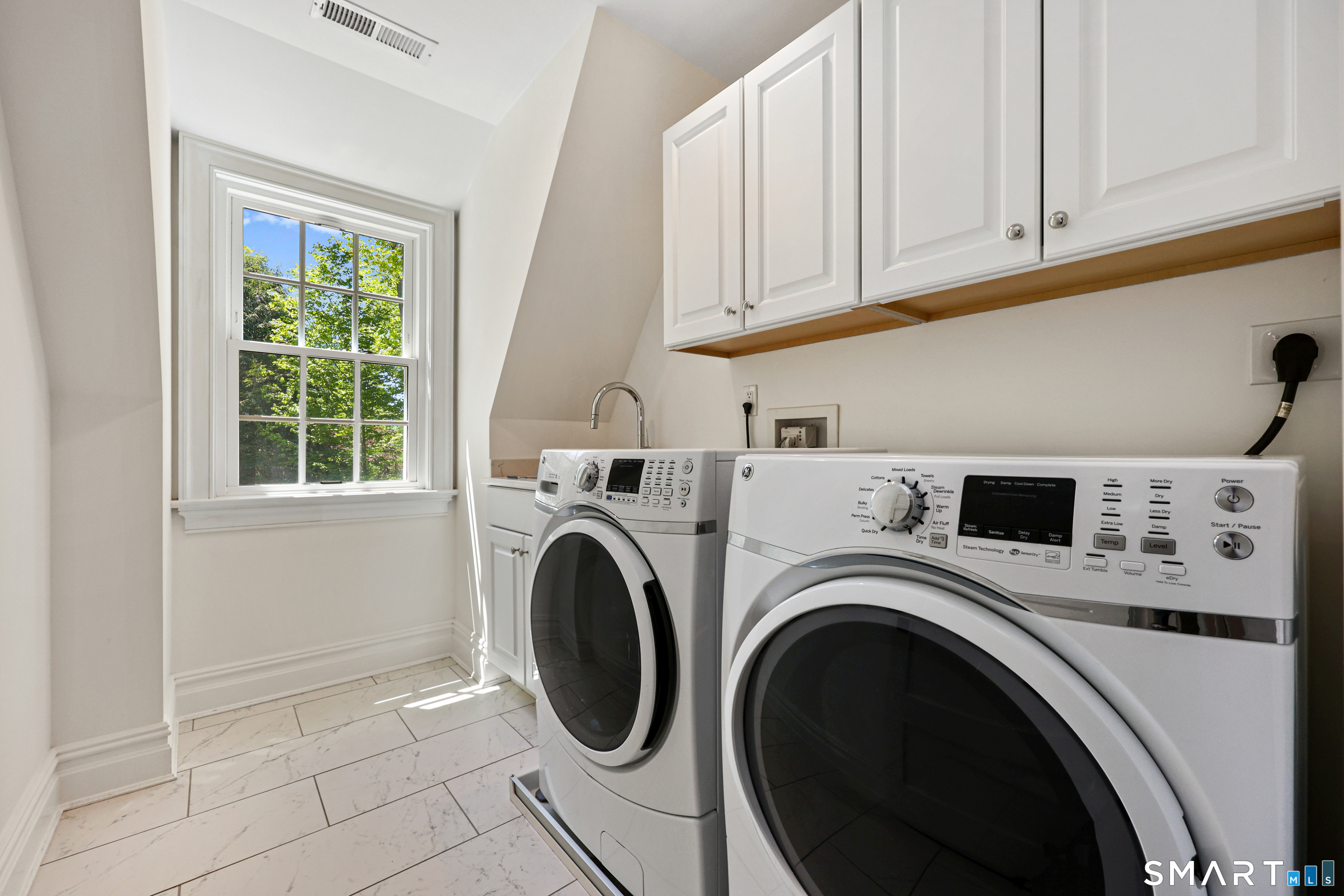 4 Old Barlow Mountain Road Ridgefield, CT 06877 - Photo 29 of 40 a view of washer and dryer with kitchen in the background