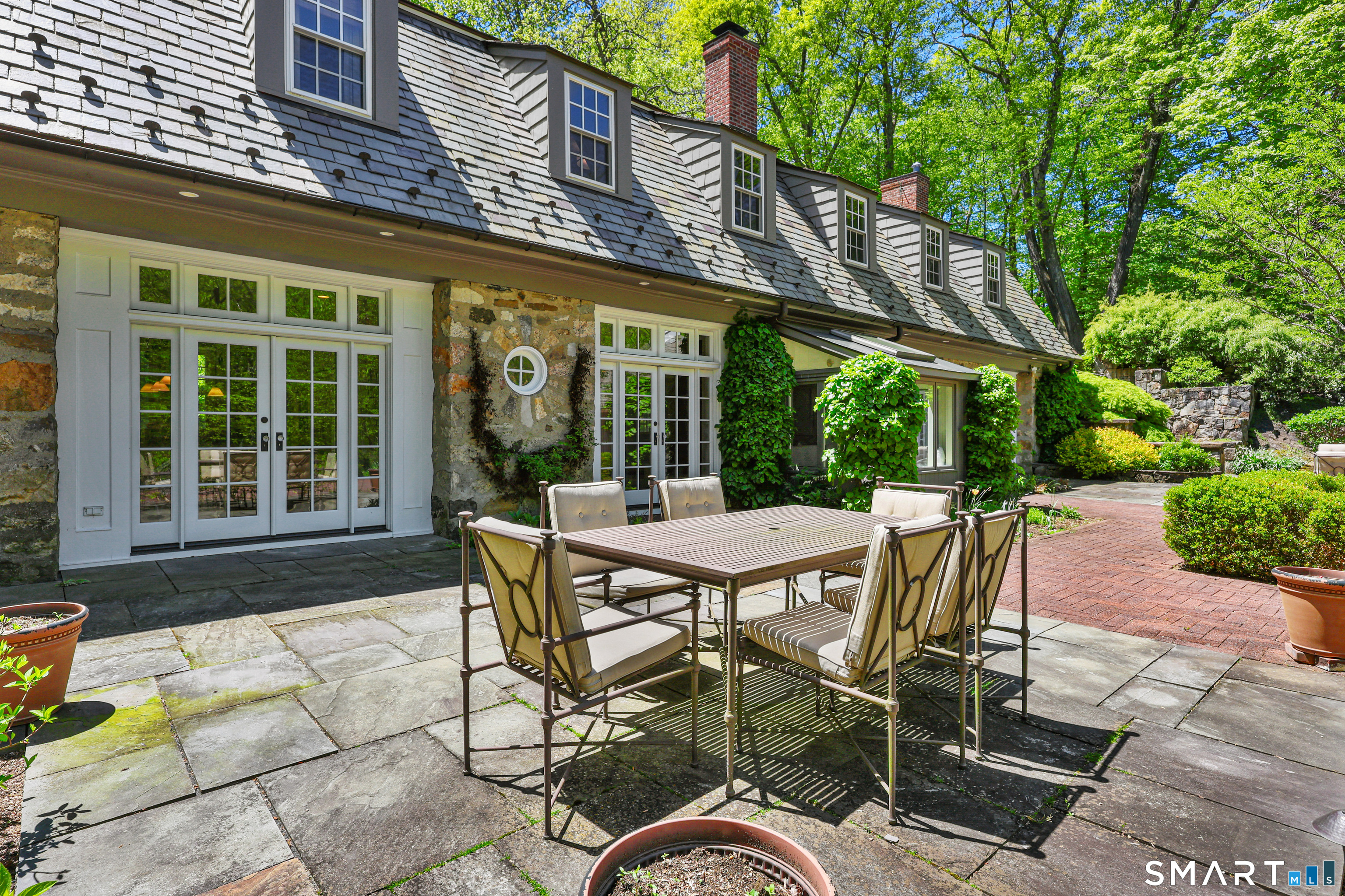 4 Old Barlow Mountain Road Ridgefield, CT 06877 - Photo 34 of 40 a view of a patio with table and chairs and potted plants