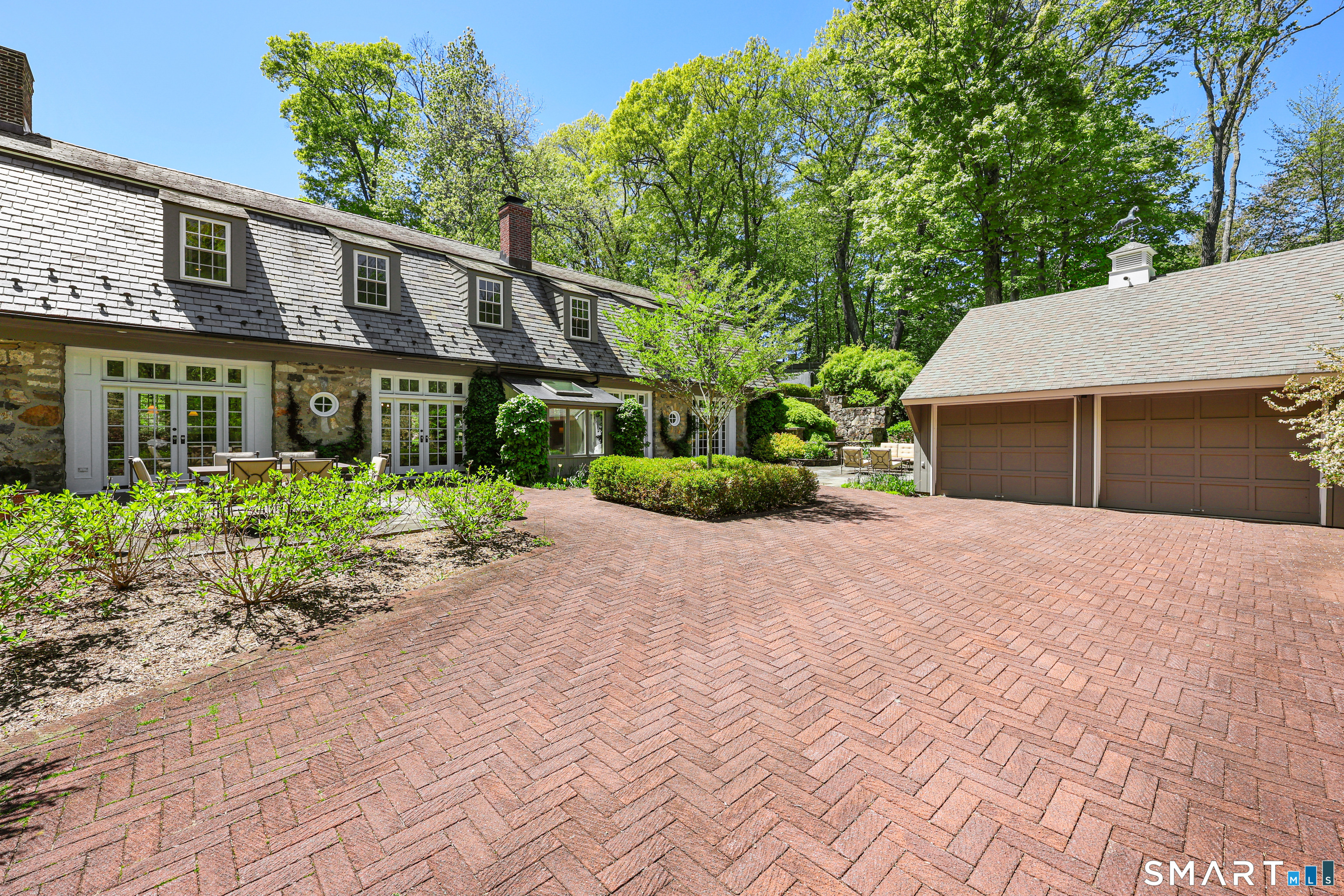 4 Old Barlow Mountain Road Ridgefield, CT 06877 - Photo 38 of 40 a front view of a house with a yard and potted plants