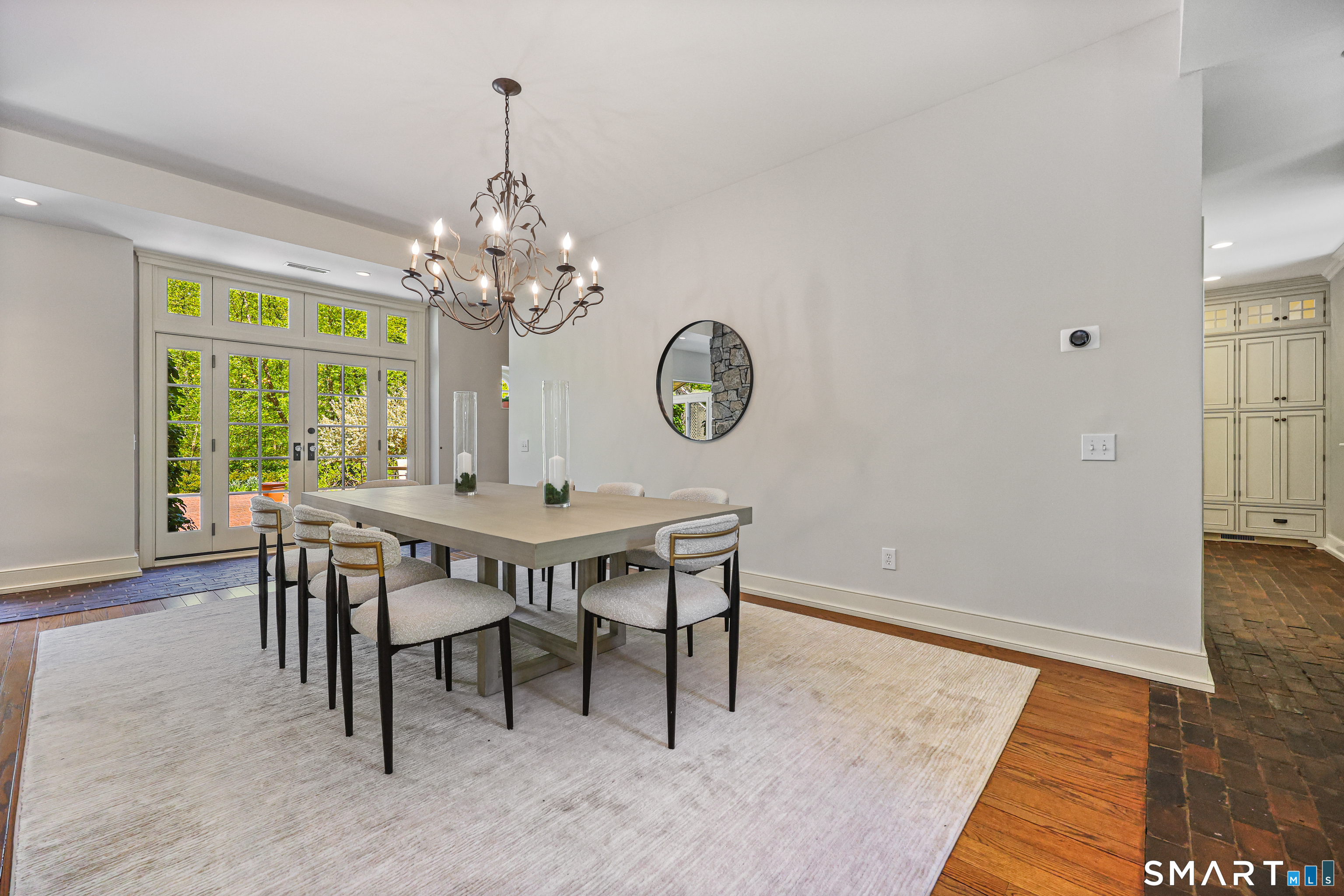 4 Old Barlow Mountain Road Ridgefield, CT 06877 - Photo 9 of 40 a dining room with wooden floor a chandelier a wooden table and chairs