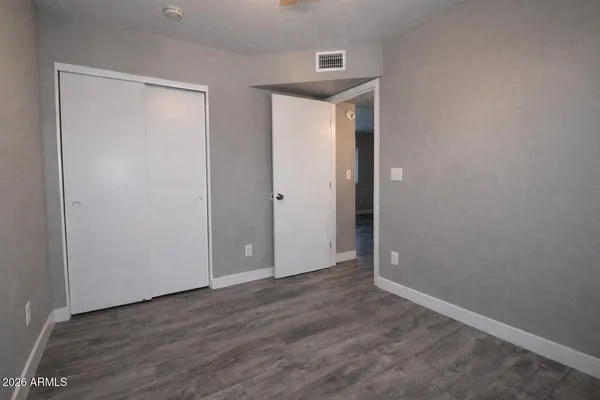 a view of an empty room with wooden floor