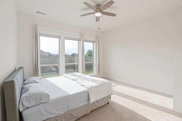 a bedroom with a large bed and a window