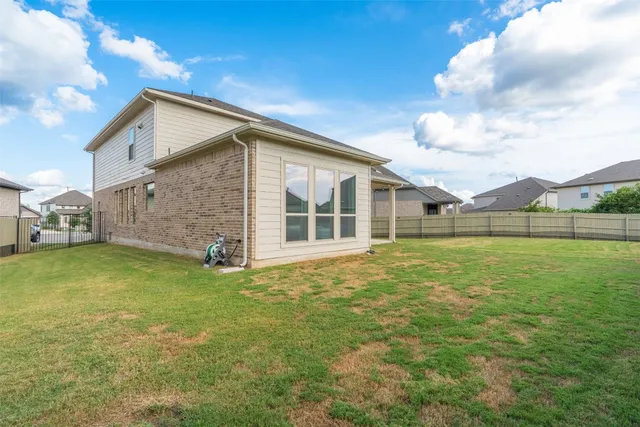 a view of a house with a backyard