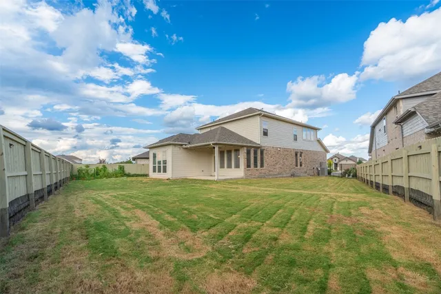 a view of a house with a backyard