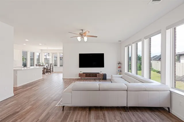 a living room with furniture wooden floor and a flat screen tv