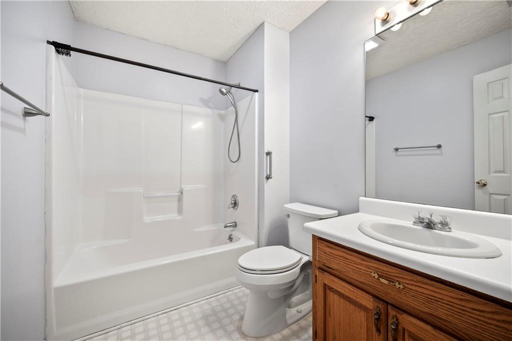 2009 Ben Higgins Road Dahlonega, GA 30533 - Photo 19 of 25 a bathroom with a sink a toilet and a mirror