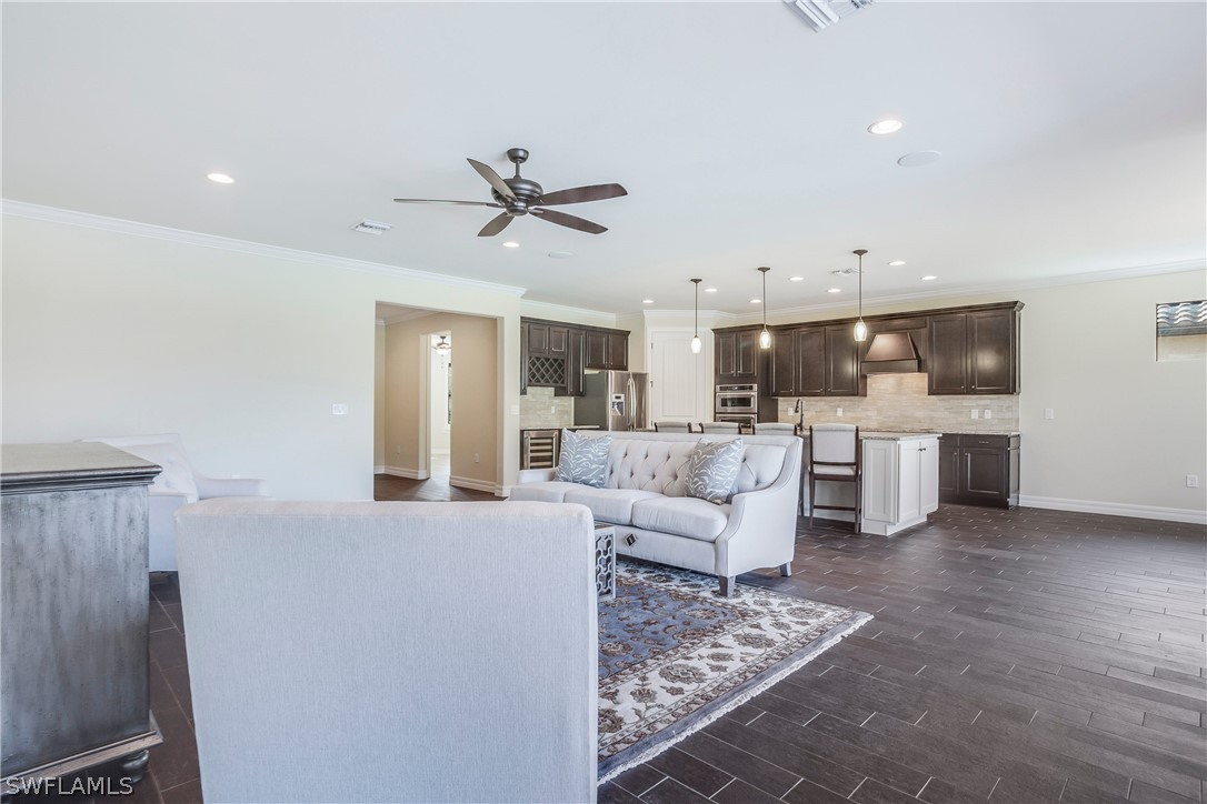 10828 Rutherford Road Fort Myers, FL 33913 - Photo 12 of 31 a living room with furniture and kitchen view