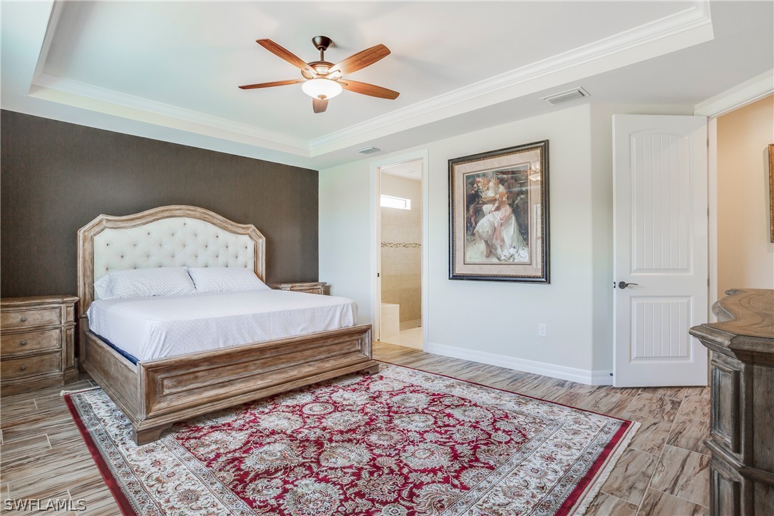 10828 Rutherford Road Fort Myers, FL 33913 - Photo 13 of 31 a bedroom with a bed and a lamp on dresser
