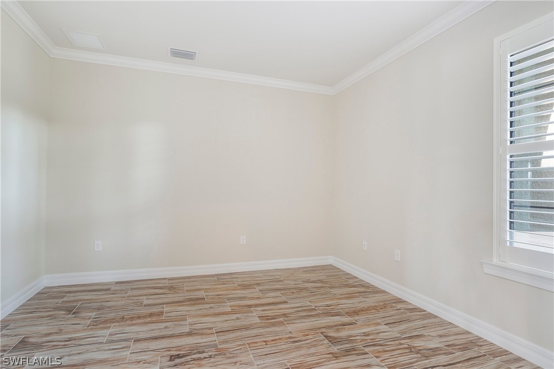 10828 Rutherford Road Fort Myers, FL 33913 - Photo 20 of 31 a view of an empty room with wooden floor and a window