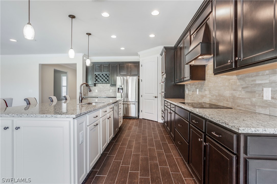 10828 Rutherford Road Fort Myers, FL 33913 - Photo 4 of 31 a kitchen with stainless steel appliances granite countertop a sink and stove