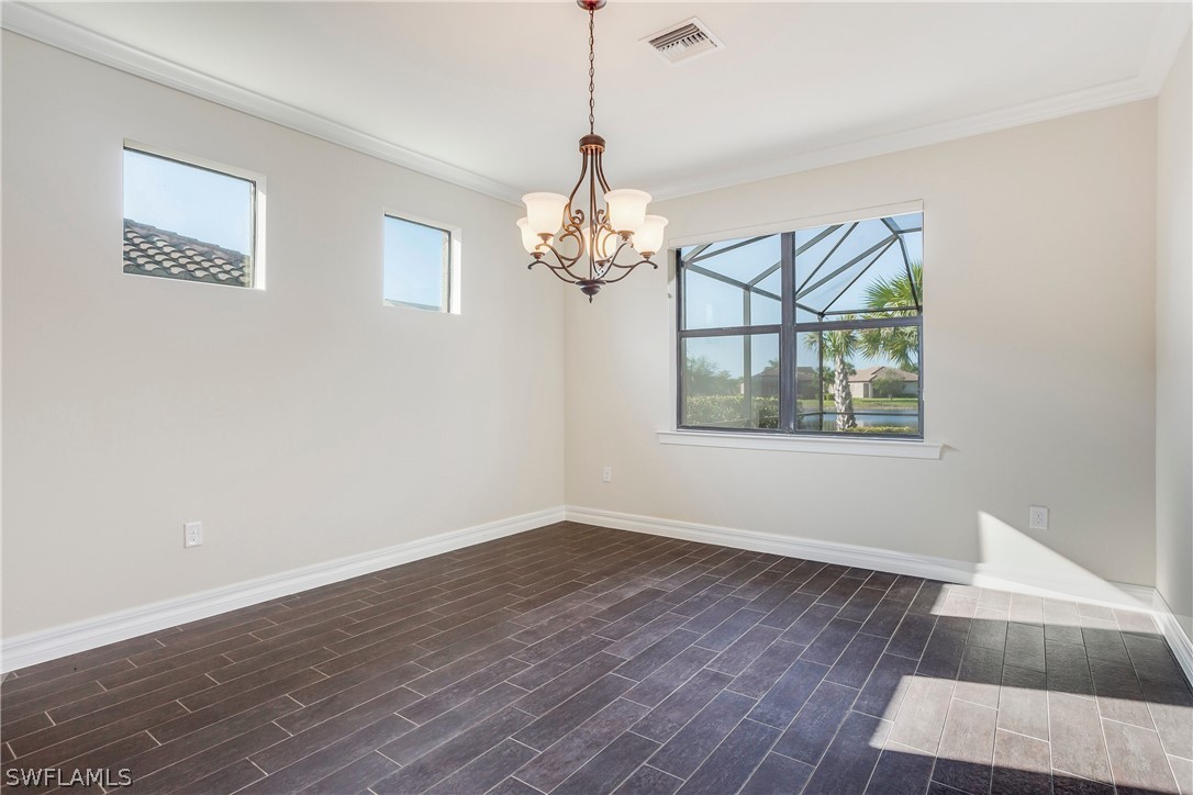 10828 Rutherford Road Fort Myers, FL 33913 - Photo 7 of 31 a window in an empty room with wooden floor