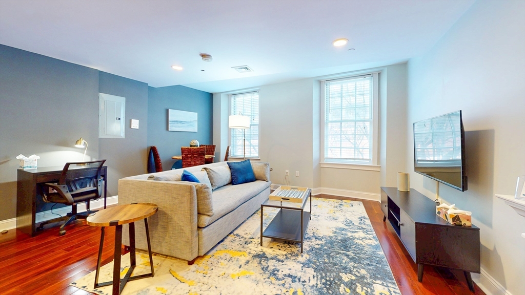 15-2 Union Street, Unit FURNISHED Boston, MA 02108 - Photo 2 of 9 a living room with furniture and a flat screen tv