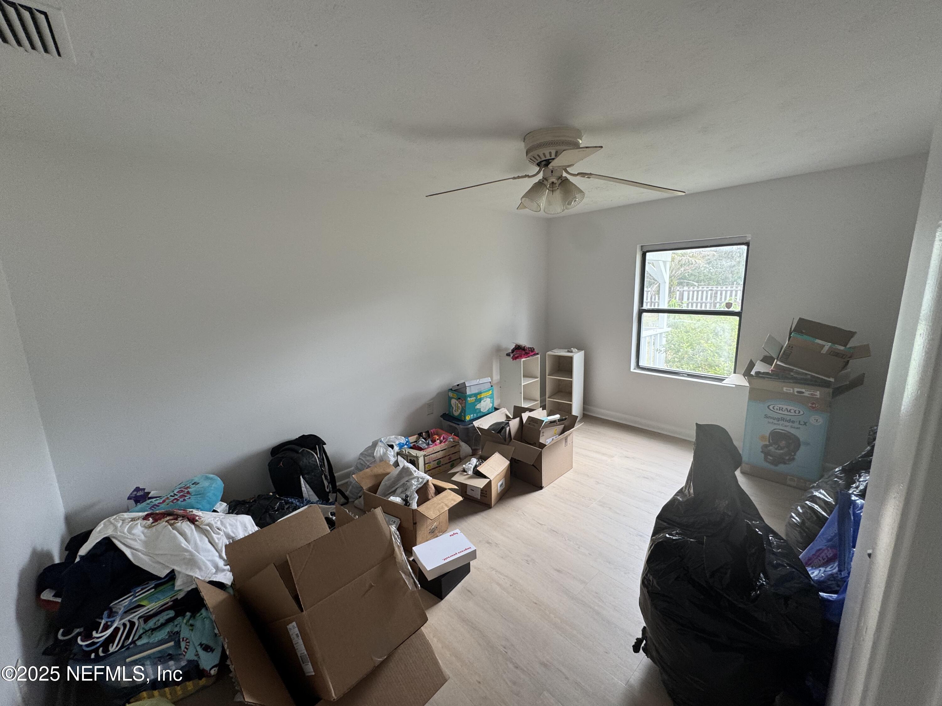 5515-5517 Shad Road Jacksonville, FL 32257 - Photo 13 of 17 a bedroom with furniture and a window