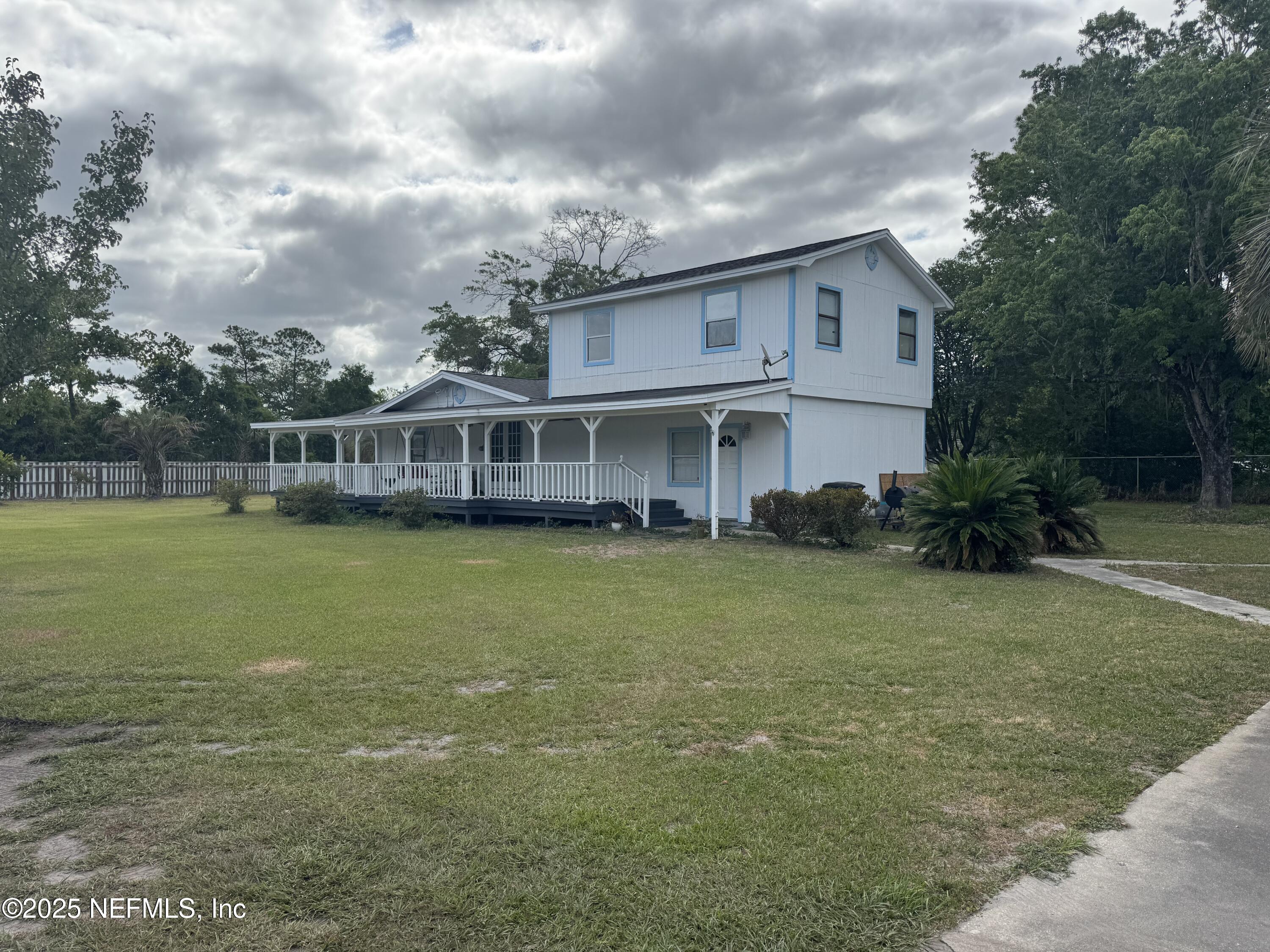 5515-5517 Shad Road Jacksonville, FL 32257 - Photo 8 of 17 a view of a house with a garden and lake view