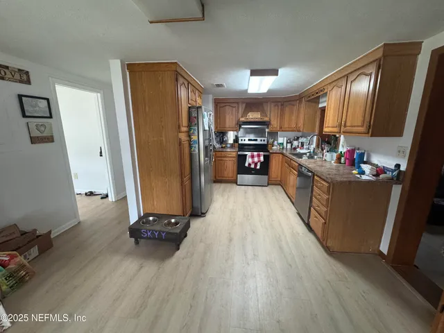 a view of a dining room with furniture and wooden floor