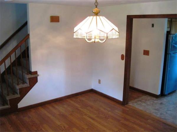 401 Mulpus Road Lunenburg, MA 01462 - Photo 3 of 15 an empty room with wooden floor and hallway