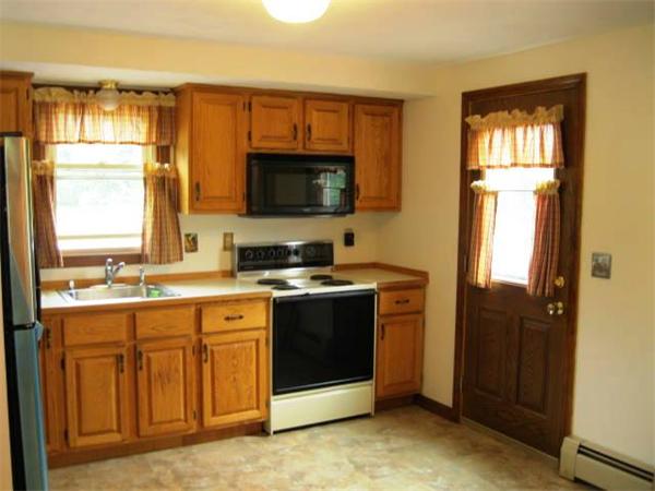 401 Mulpus Road Lunenburg, MA 01462 - Photo 6 of 15 a view of a kitchen with a stove cabinets and a window