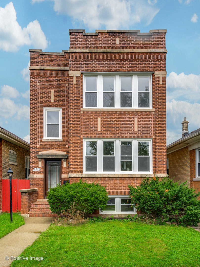2919 North Kilpatrick Avenue, Unit 2 Chicago, IL 60641 - Photo 1 of 17 a front view of a building with a yard
