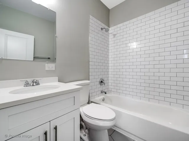 a bathroom with a sink a toilet and bathtub