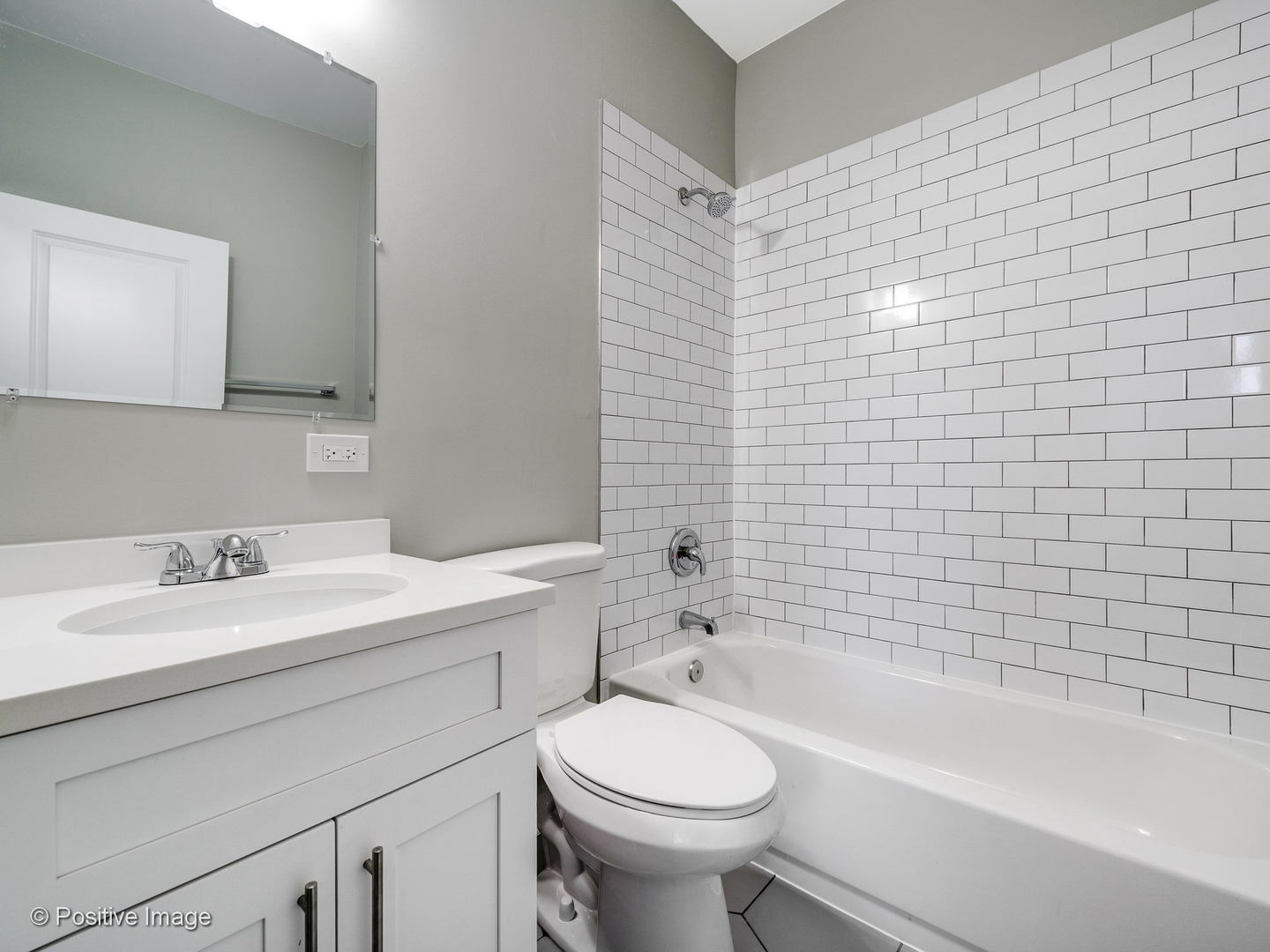 2919 North Kilpatrick Avenue, Unit 2 Chicago, IL 60641 - Photo 11 of 17 a bathroom with a sink a toilet and bathtub