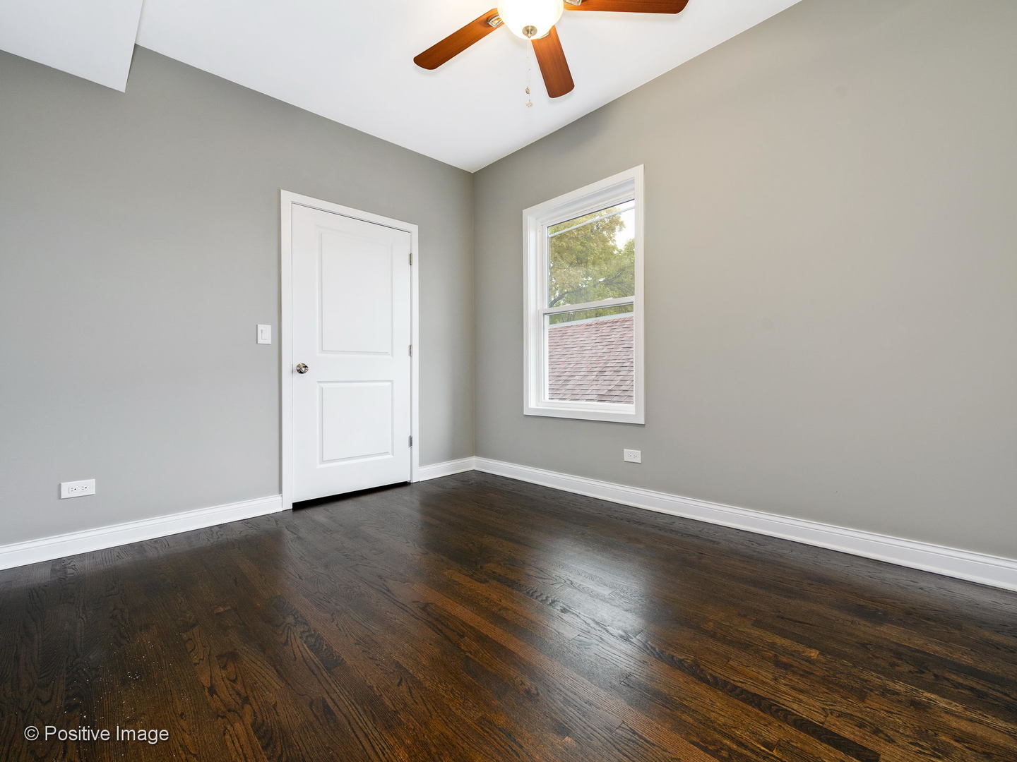 2919 North Kilpatrick Avenue, Unit 2 Chicago, IL 60641 - Photo 12 of 17 an empty room with wooden floor and windows