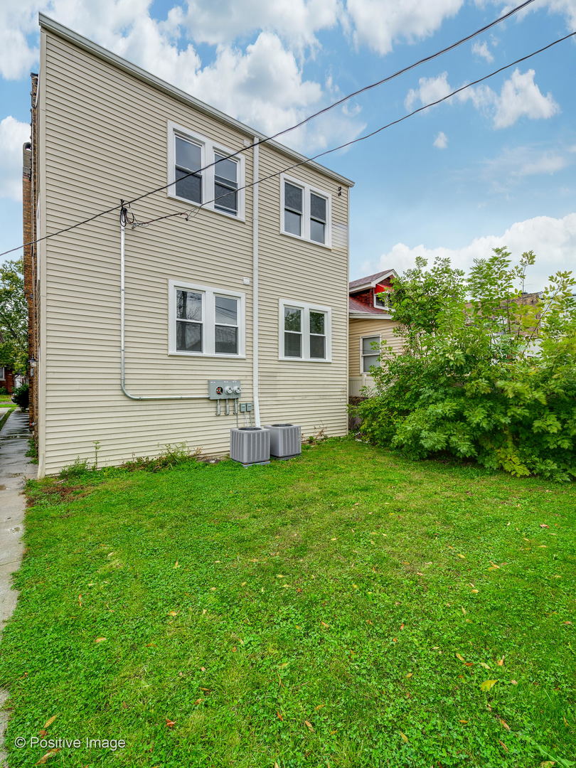 2919 North Kilpatrick Avenue, Unit 2 Chicago, IL 60641 - Photo 17 of 17 a brick house with a small yard front of it