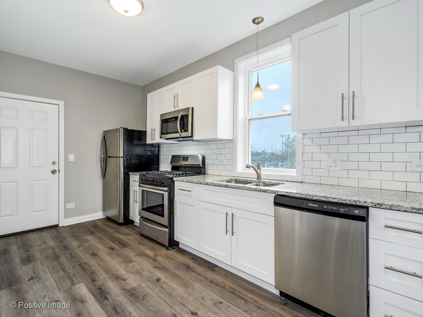 2919 North Kilpatrick Avenue, Unit 2 Chicago, IL 60641 - Photo 2 of 17 a kitchen with a sink stove and microwave