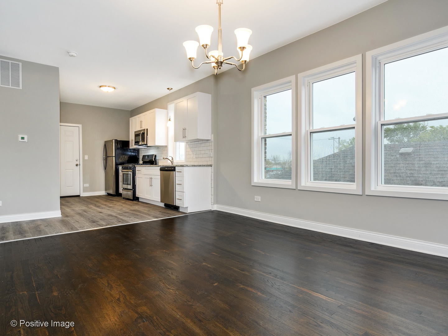 2919 North Kilpatrick Avenue, Unit 2 Chicago, IL 60641 - Photo 5 of 17 a view of a kitchen with a stove wooden cabinets and a window