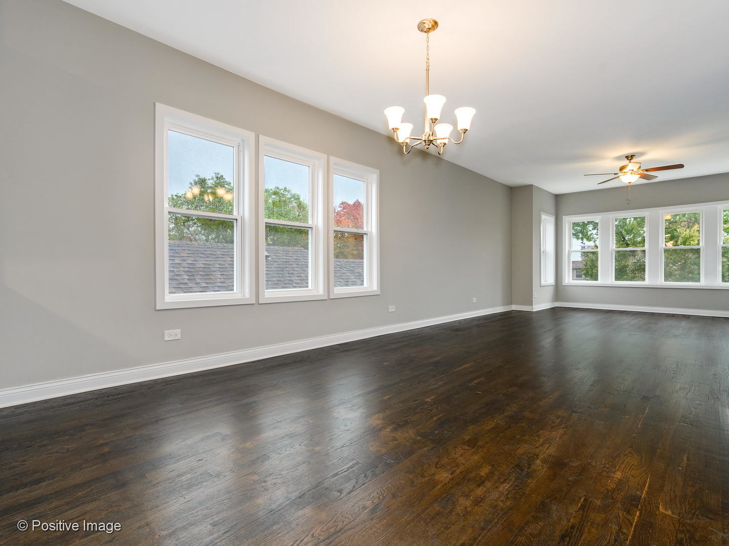 2919 North Kilpatrick Avenue, Unit 2 Chicago, IL 60641 - Photo 6 of 17 a view of an empty room with wooden floor and a window