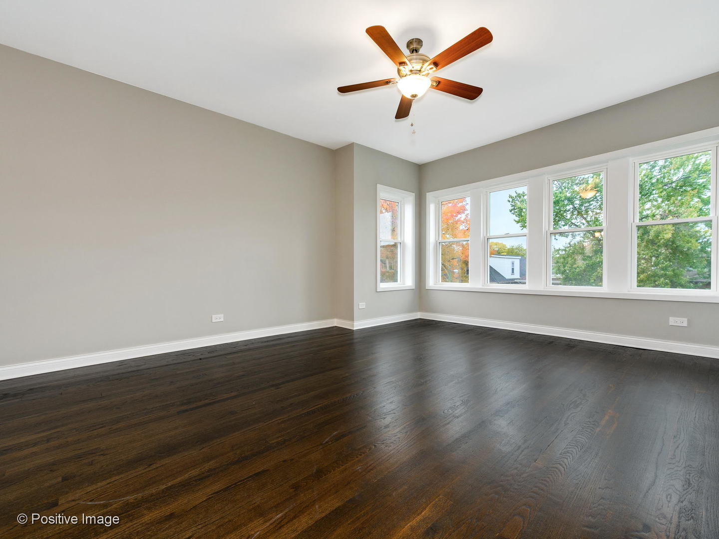 2919 North Kilpatrick Avenue, Unit 2 Chicago, IL 60641 - Photo 7 of 17 a view of an empty room with wooden floor and a window