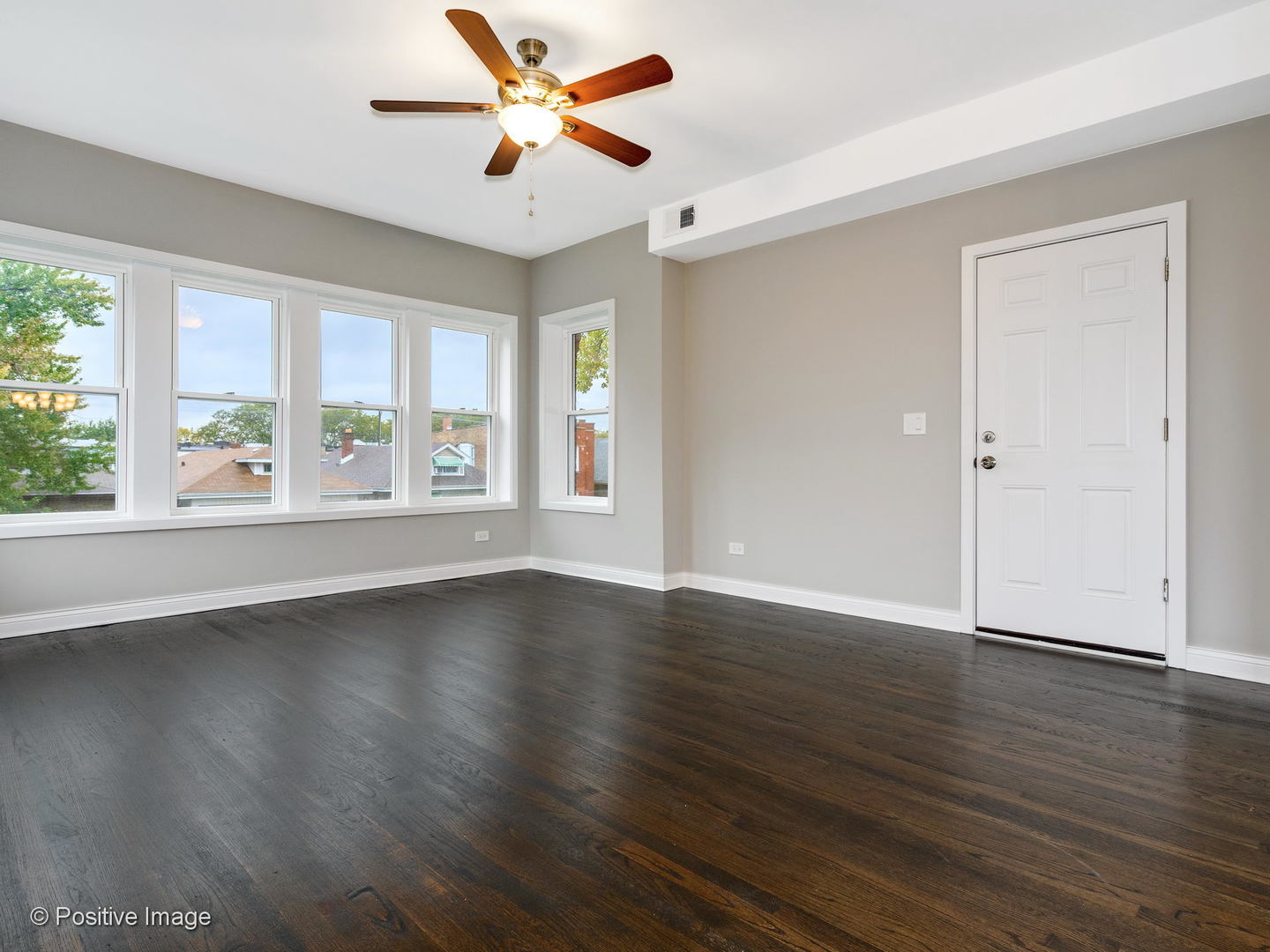 2919 North Kilpatrick Avenue, Unit 2 Chicago, IL 60641 - Photo 8 of 17 a view of an empty room with wooden floor and a window
