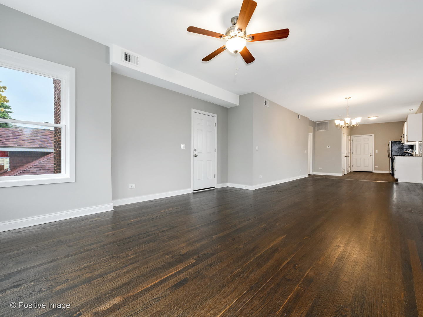 2919 North Kilpatrick Avenue, Unit 2 Chicago, IL 60641 - Photo 9 of 17 a view of an empty room with wooden floor and a window