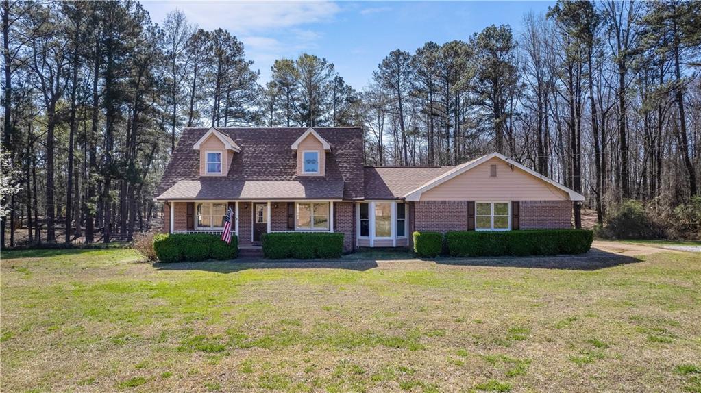 1135 Bethany Road Covington, GA 30016 - Photo 1 of 1 a front view of a house with garden