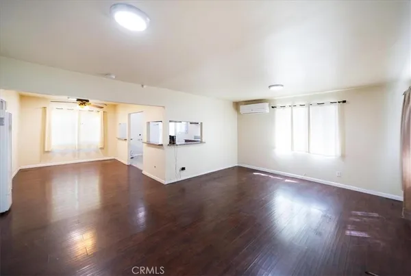 a view of wooden floor and windows in a room