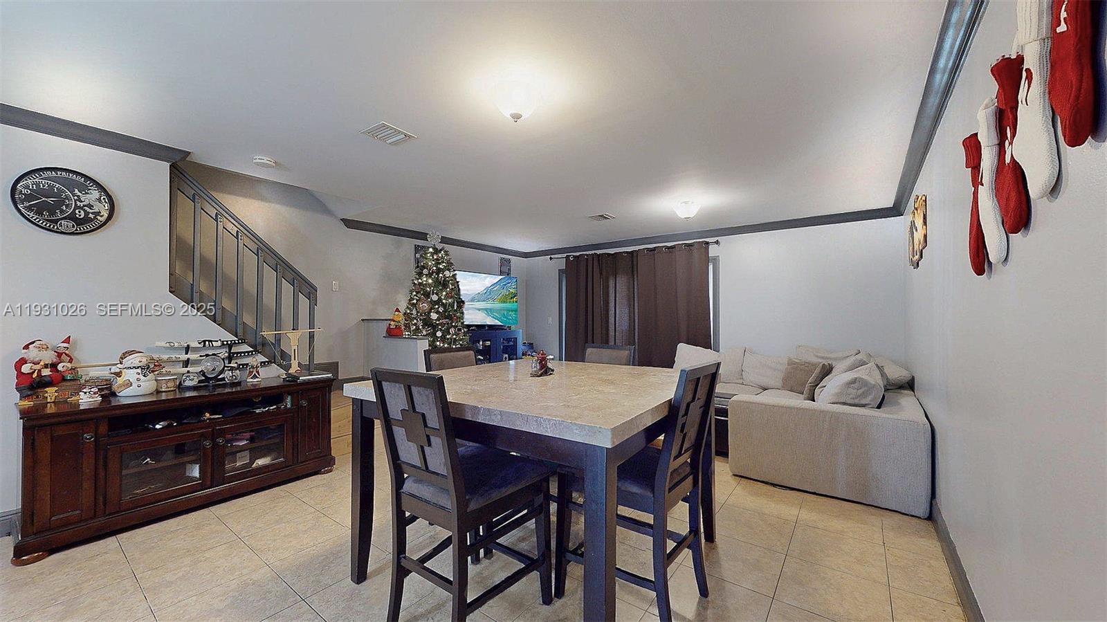 6279 Southwest 128th Court Miami, FL 33183 - Photo 12 of 32 a view of a dining room with furniture and a ceiling fan