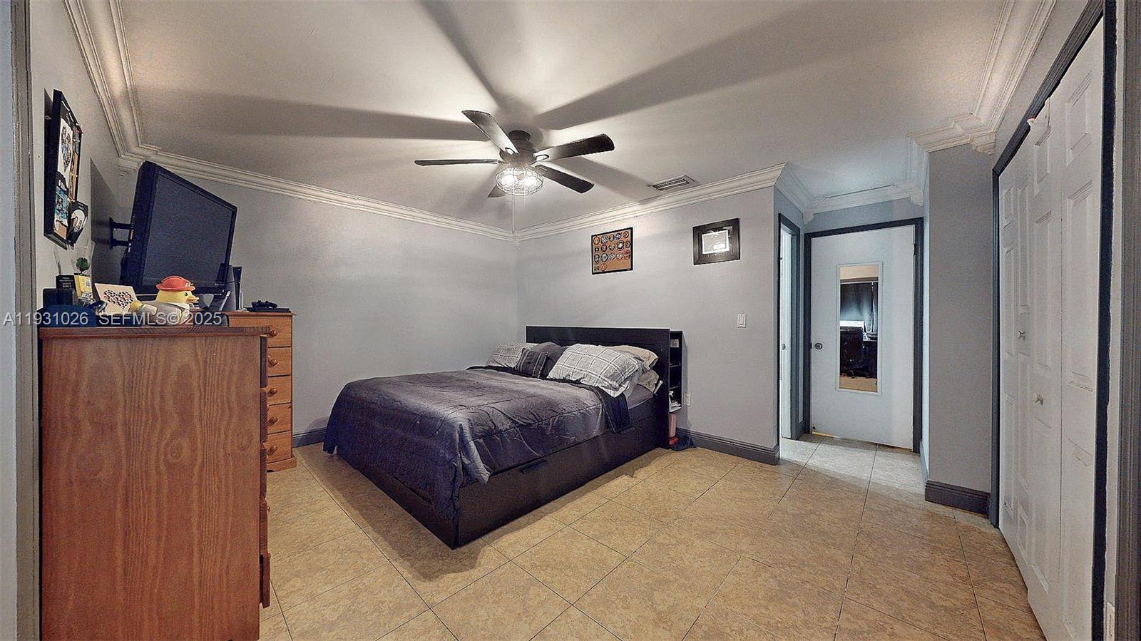 6279 Southwest 128th Court Miami, FL 33183 - Photo 23 of 32 a bedroom with a bed and a ceiling fan