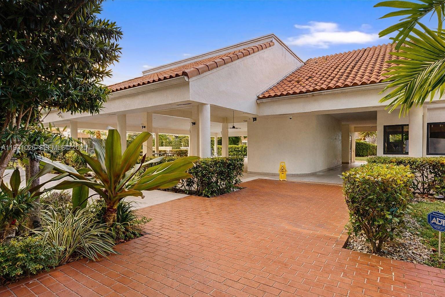 6279 Southwest 128th Court Miami, FL 33183 - Photo 28 of 32 a view of a house with wooden walls and potted plants