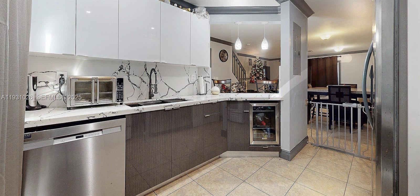 6279 Southwest 128th Court Miami, FL 33183 - Photo 5 of 32 a kitchen with stainless steel appliances granite countertop a sink a stove and a refrigerator