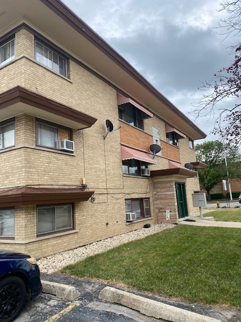 2939 South 13th Avenue, Unit GS Broadview, IL 60155 - Photo 3 of 3 a front view of a house with a garden