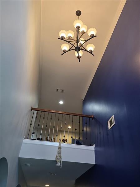 6850 Rocking Horse Lane Cumming, GA 30040 - Photo 3 of 36 a view of hallway with a table and chandelier