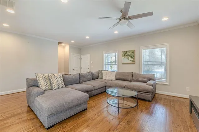 a kitchen with stainless steel appliances granite countertop a sink a stove and a wooden floors