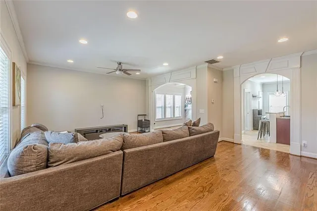 a kitchen with stainless steel appliances granite countertop a refrigerator a sink a stove a dining table and chairs