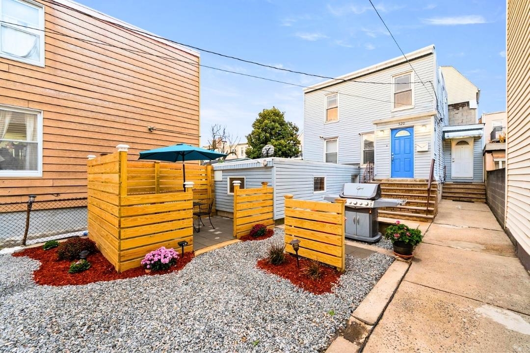 a view of a two chairs in the patio